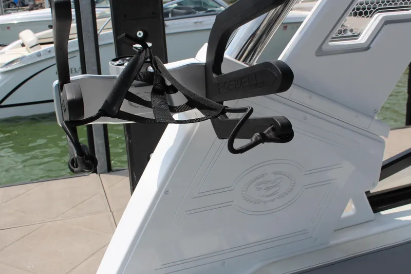Slide: The Image of 2025 Cobalt R8 Surf boat detail with wakeboard rack at marina. - 16