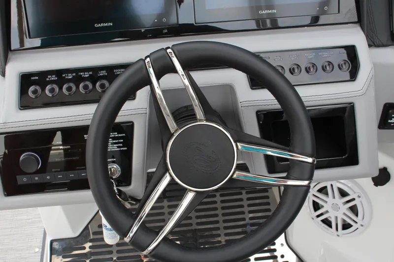 Slide: The Image of Steering wheel and dashboard of 2025 Cobalt R8 Surf boat with Garmin displays. - 21
