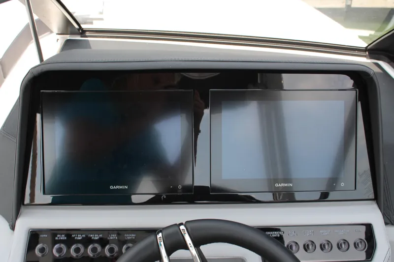 Slide: The Image of 2025 Cobalt R8 Surf dashboard with dual Garmin displays and control panel. - 22