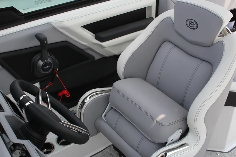 Slide: The Image of 2025 Cobalt R8 Surf boat interior with gray captain's seat and steering wheel. - 24