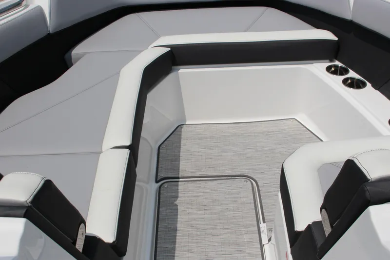 Slide: The Image of 2025 Cobalt R8 Surf boat interior with cushioned seating and cup holders. - 25