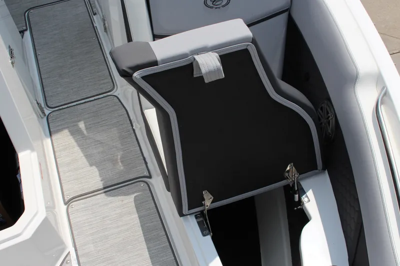 Slide: The Image of 2025 Cobalt R8 Surf boat interior with open storage compartment and cushioned seating. - 29