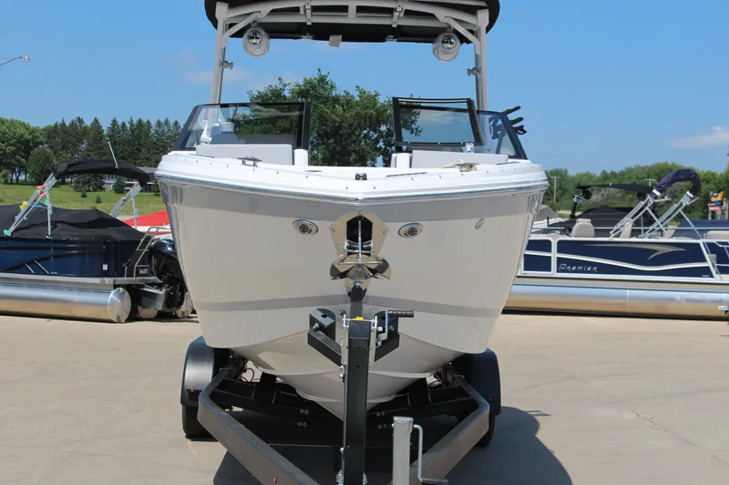 Slide: The Image of 2025 Cobalt R8 Surf boat on trailer, displayed outdoors with other boats. - 37