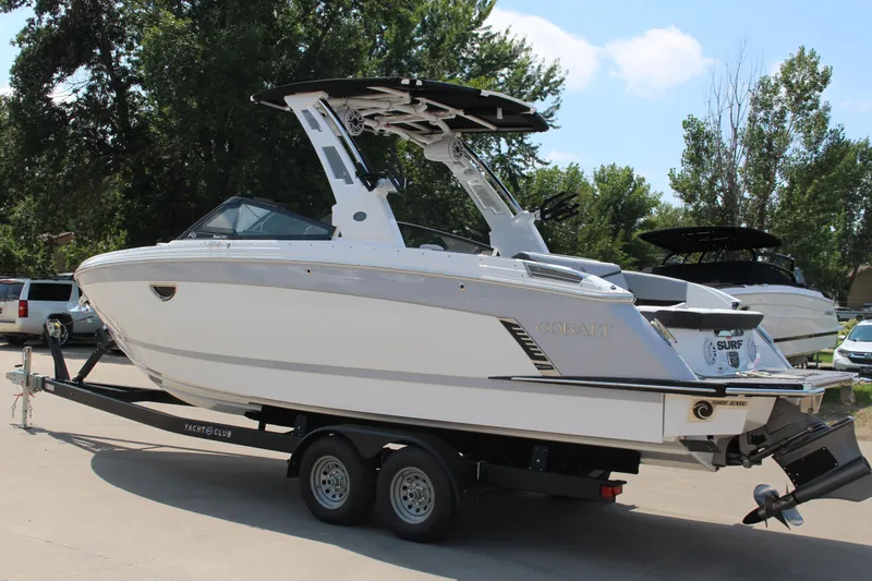 Slide: The Image of 2025 Cobalt R8 Surf boat on trailer, parked outdoors. - 38