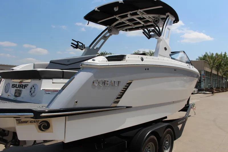 Slide: The Image of 2025 Cobalt R8 Surf boat on trailer, sleek design, sunny day background. - 42