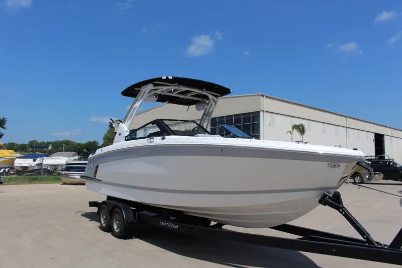 Slide: The Image of 2025 Cobalt R8 Surf boat on trailer under clear blue sky. - 44