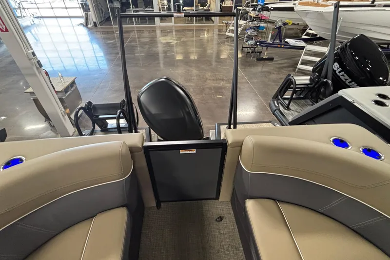 Slide: The Image of 2026 Viaggio Z24U boat interior with beige seating and Suzuki outboard motor in showroom. - 12