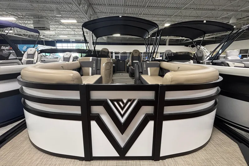 Slide: The Image of 2026 Viaggio Z24U pontoon boat with sleek design and spacious seating in showroom. - 2