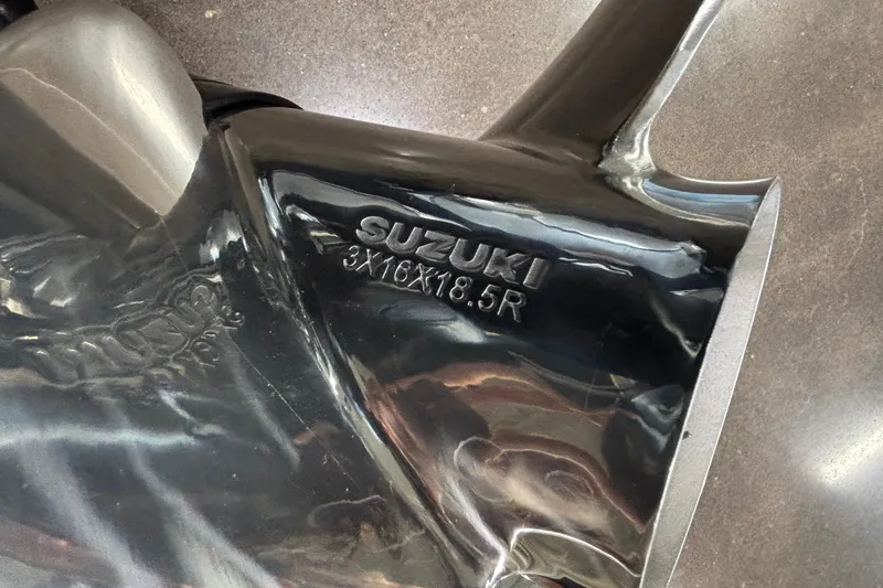 Slide: The Image of Close-up of a black Viaggio Z24U 2026 part with Suzuki branding and specifications. - 5