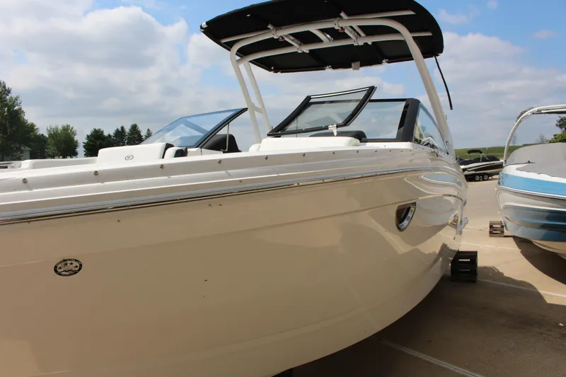 Slide: The Image of 2025 Cobalt R8 boat with sleek design, docked under a partly cloudy sky. - 12