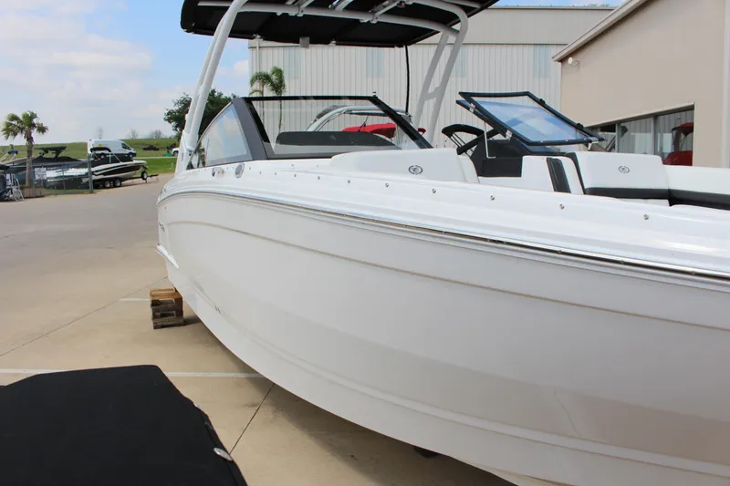 Slide: The Image of 2025 Cobalt R8 boat in a marina setting, showcasing sleek design and modern features. - 3