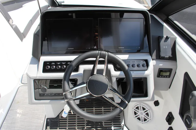 Slide: The Image of 2025 Cobalt R8 boat dashboard with dual Garmin displays and modern steering wheel. - 4