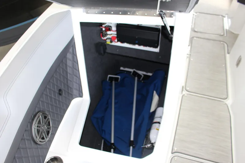 Slide: The Image of Storage compartment of 2025 Cobalt R8 boat with equipment and speaker. - 11