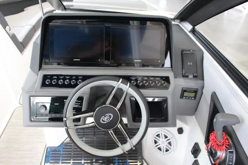 Slide: The Image of 2025 Cobalt R8 boat dashboard with dual Garmin screens and modern steering wheel. - 16