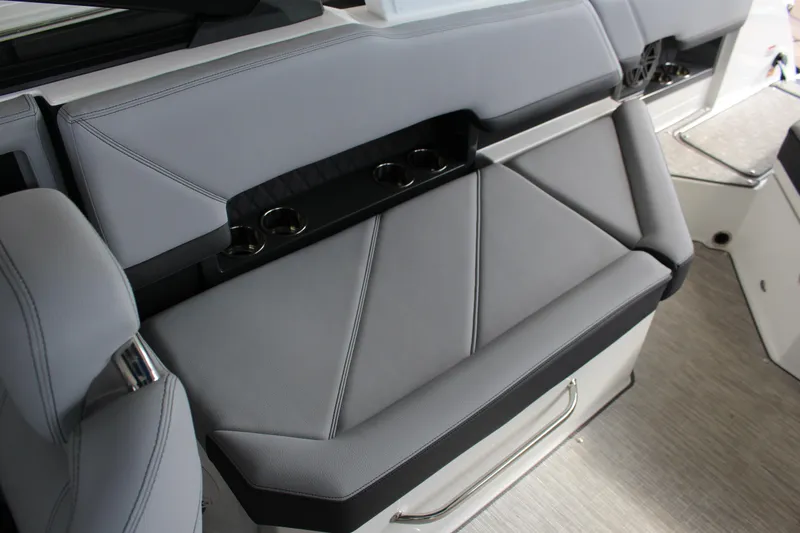 Slide: The Image of 2025 Cobalt R8 boat interior with sleek gray seating and integrated cup holders. - 19