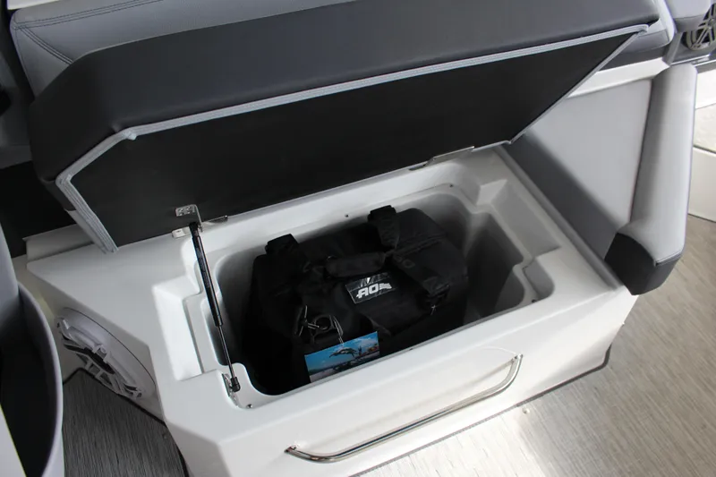 Slide: The Image of 2025 Cobalt R8 boat storage compartment with black bag inside. - 20
