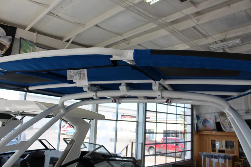 Slide: The Image of 2025 Cobalt R8 boat with blue canopy in showroom. - 27