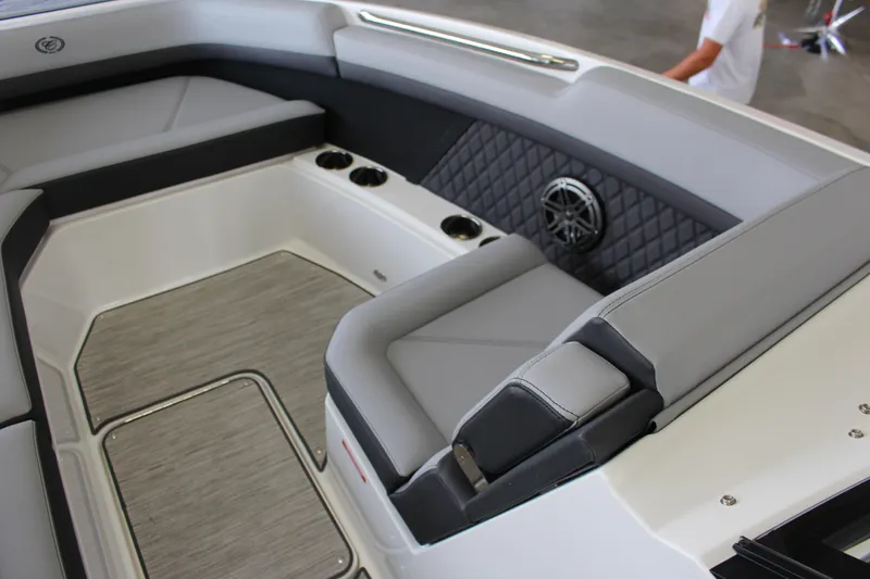 Slide: The Image of 2025 Cobalt R8 boat interior with gray seating, cup holders, and speaker. - 8