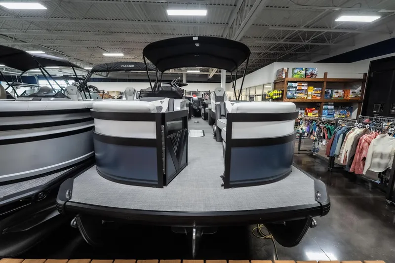 Slide: The Image of 2026 Viaggio D22U pontoon boat displayed in a showroom with retail items nearby. - 12