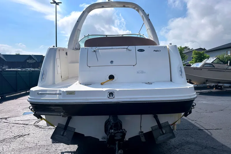 Slide: The Image of 2006 Sea Ray 260 Sundancer boat, rear view, parked outdoors on a sunny day. - 10