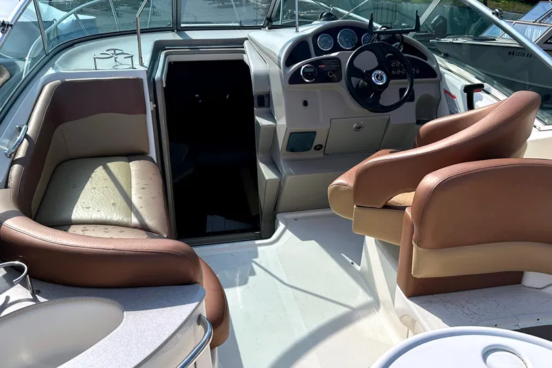Slide: The Image of 2006 Sea Ray 260 Sundancer boat interior with helm, seating, and dashboard. - 16