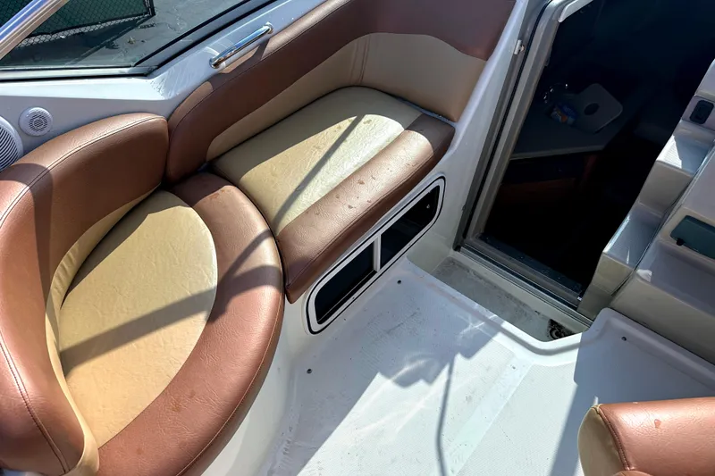 Slide: The Image of 2006 Sea Ray 260 Sundancer interior seating area with brown and beige upholstery. - 20
