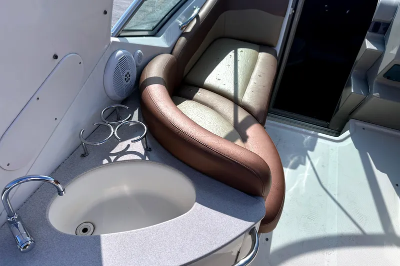 Slide: The Image of Interior of 2006 Sea Ray 260 Sundancer with sink, cup holders, and seating. - 21