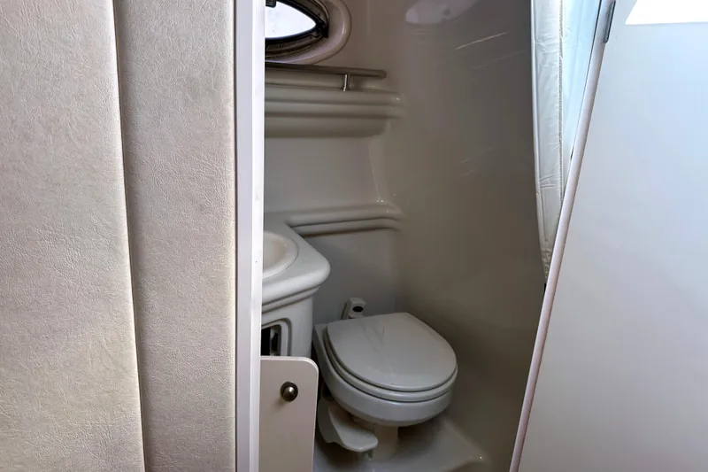 Slide: The Image of Interior view of 2006 Sea Ray 260 Sundancer bathroom with toilet and sink. - 24