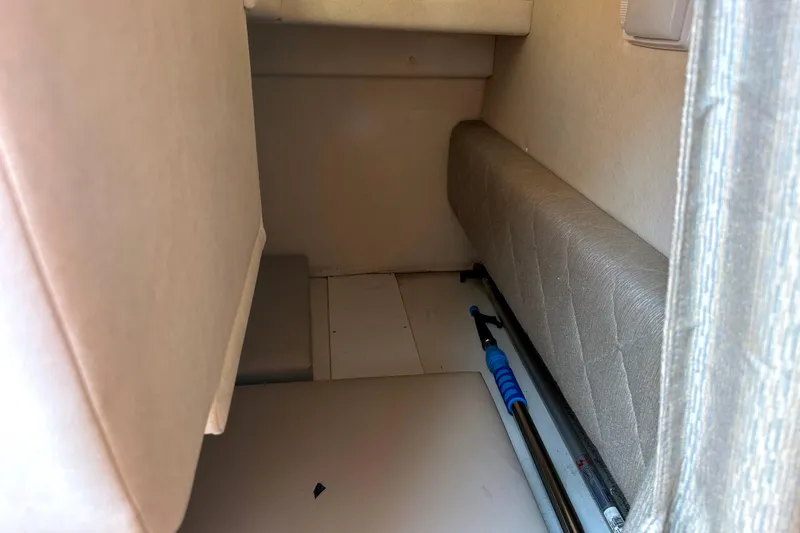 Slide: The Image of Interior cabin of 2006 Sea Ray 260 Sundancer boat, featuring seating and storage space. - 26