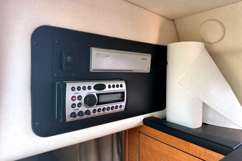 Slide: The Image of Control panel of a 2006 Sea Ray 260 Sundancer with stereo system and paper towels. - 28