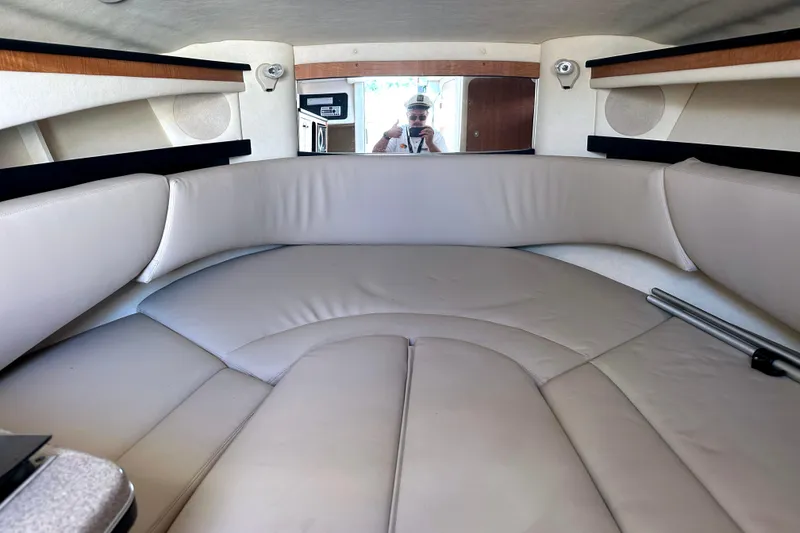 Slide: The Image of Interior cabin of 2006 Sea Ray 260 Sundancer with beige seating and wood accents. - 29