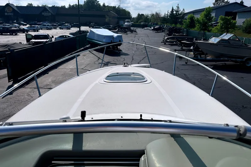 Slide: The Image of 2006 Sea Ray 260 Sundancer boat deck view in a marina parking lot. - 30