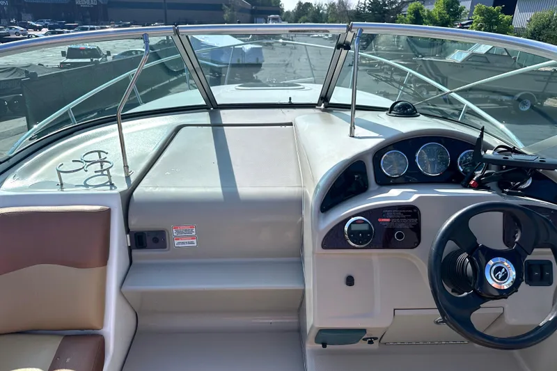 Slide: The Image of 2006 Sea Ray 260 Sundancer boat dashboard with steering wheel and instrument panel. - 31