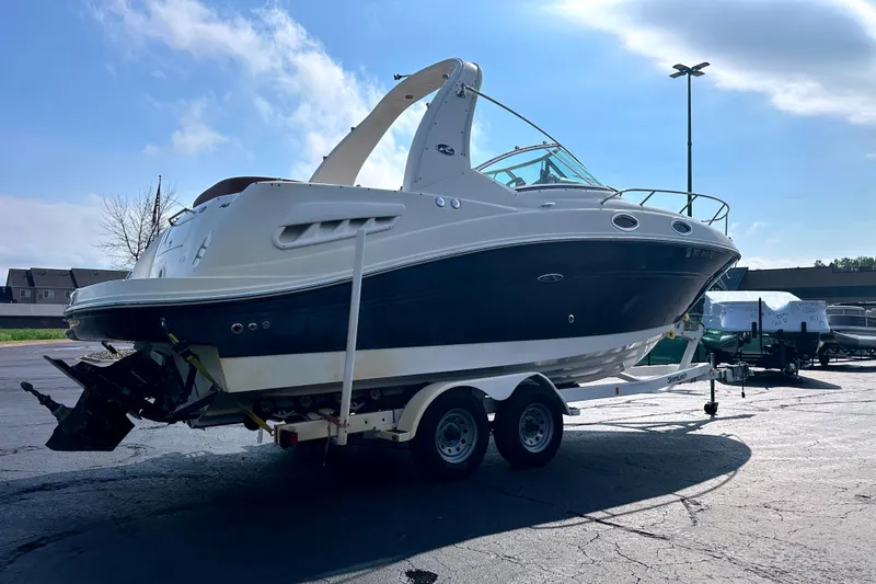 Slide: The Image of 2006 Sea Ray 260 Sundancer boat on trailer under clear blue sky. - 6