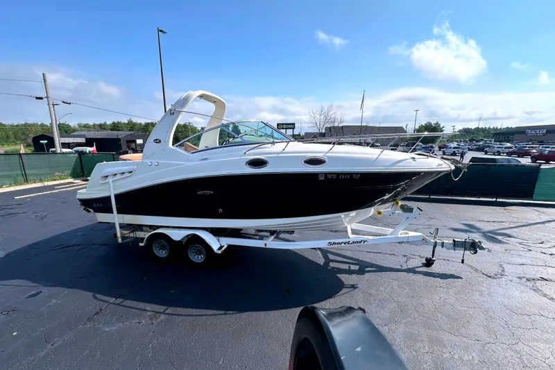 Slide: The Image of 2006 Sea Ray 260 Sundancer boat on trailer in sunny parking lot. - 9