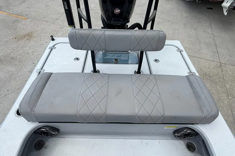 Slide: The Image of 2023 ZCB Curlew 18 boat with gray cushioned seating and diamond stitching. - 11