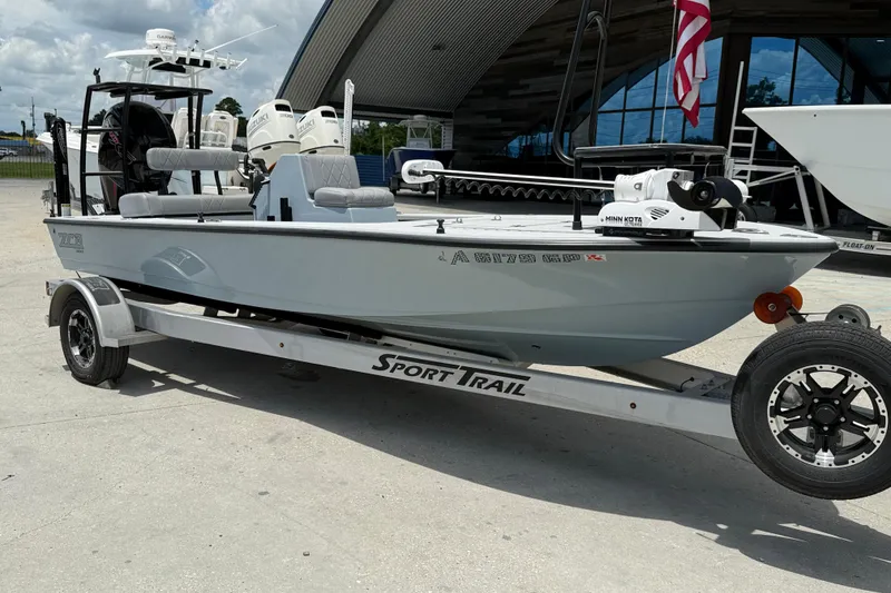 Slide: The Image of 2023 ZCB Curlew 18 boat on Sport Trail trailer, equipped with Minn Kota motor. - 2