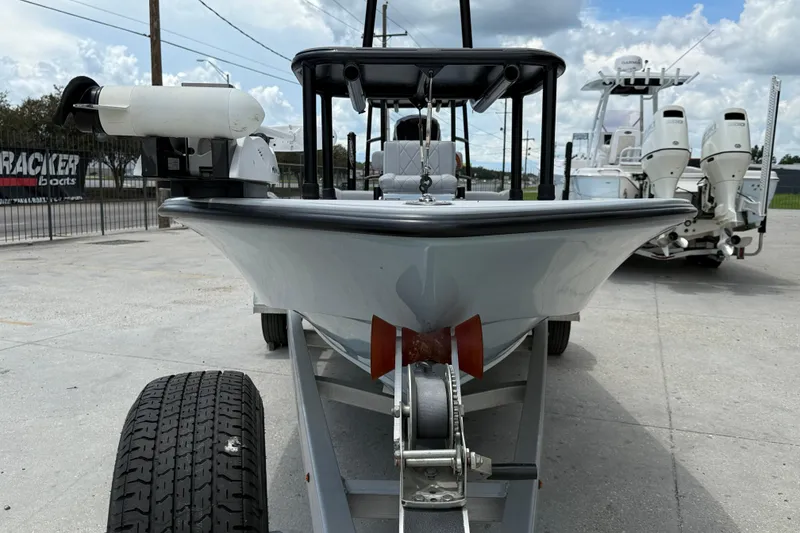 Slide: The Image of 2023 ZCB Curlew 18 boat on trailer, parked outdoors under cloudy sky. - 3