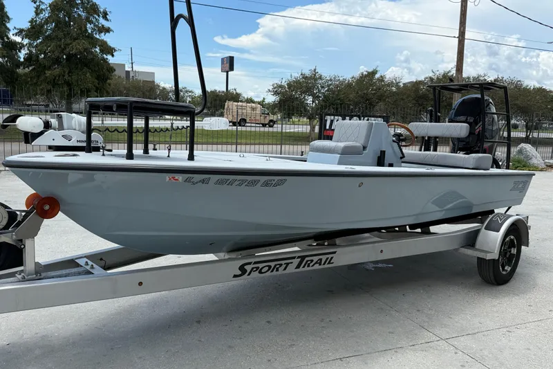 Slide: The Image of 2023 ZCB Curlew 18 boat on Sport Trail trailer, parked outdoors. - 4