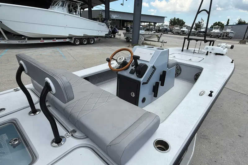 Slide: The Image of 2023 ZCB Curlew 18 boat with modern console and seating, docked in a marina. - 8