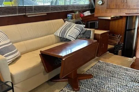 Slide: The Image of Interior of 1984 Post 43 Sport Fisherman with sofa, table, and kitchen area. - 10