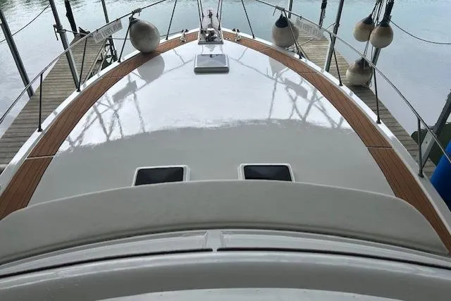 Slide: The Image of 1984 Post 43 Sport Fisherman boat deck with wooden trim and docked surroundings. - 7
