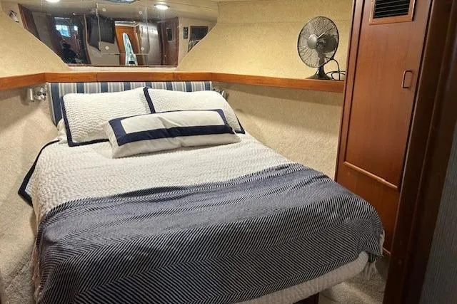 Slide: The Image of Cozy bedroom in 1984 Post 43 Sport Fisherman yacht with striped bedding and fan. - 16
