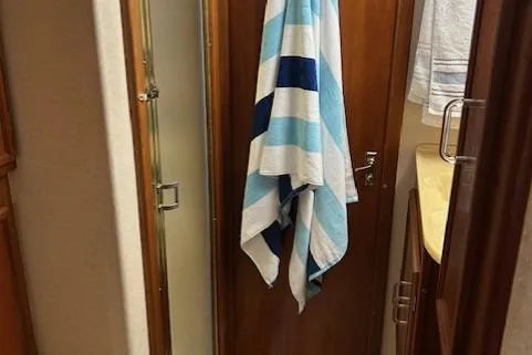Slide: The Image of 1984 Post 43 Sport Fisherman bathroom with striped towel and shower. - 17