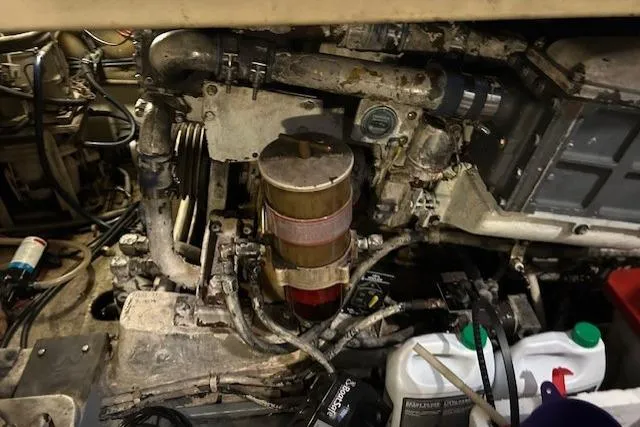 Slide: The Image of Engine room of a 1984 Post 43 Sport Fisherman boat, showing mechanical components and maintenance supplies. - 20