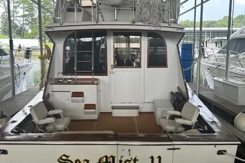 Slide: The Image of 1984 Post 43 Sport Fisherman boat docked in a marina, rear view. - 3