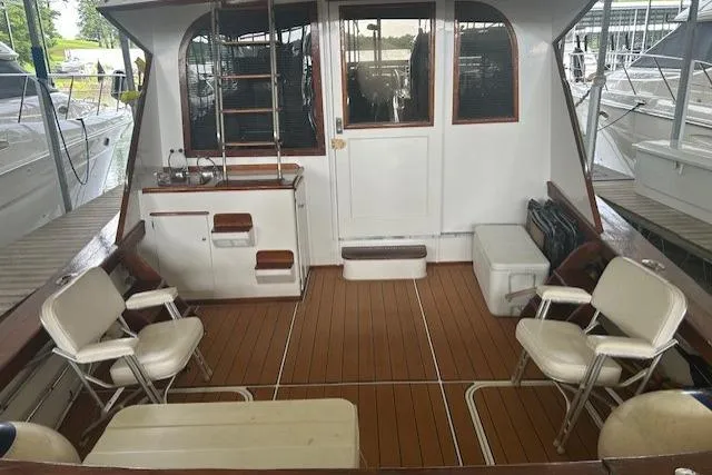 Slide: The Image of 1984 Post 43 Sport Fisherman boat interior with seating and wooden deck. - 4