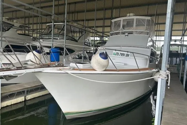 Slide: The Image of 1984 Post 43 Sport Fisherman boat docked in a covered marina. - 5