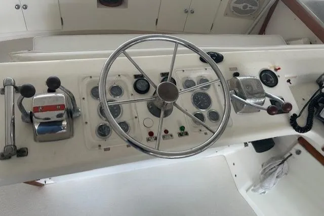 Slide: The Image of 1984 Post 43 Sport Fisherman boat helm with steering wheel and control panel. - 8