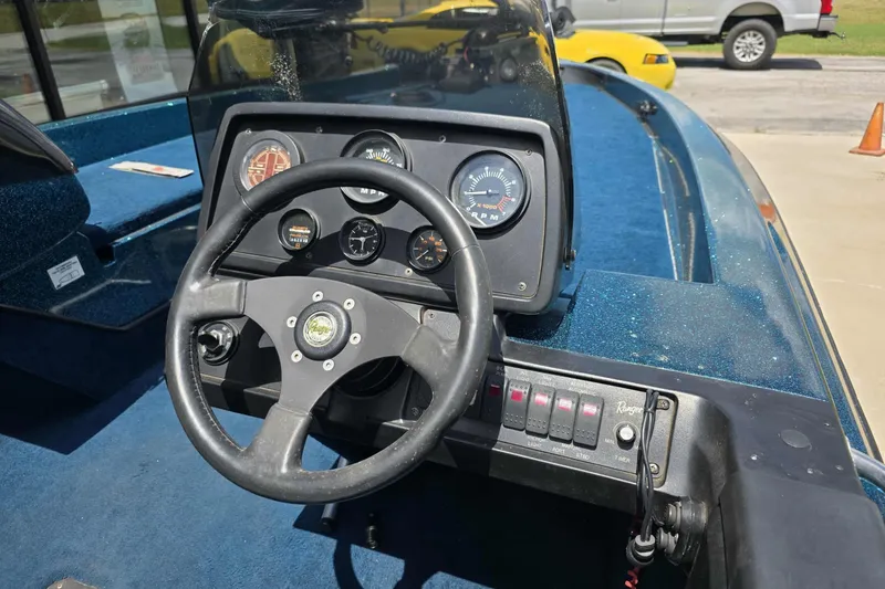 Slide: The Image of 1994 Ranger 482 V boat dashboard with steering wheel and instrument panel. - 4